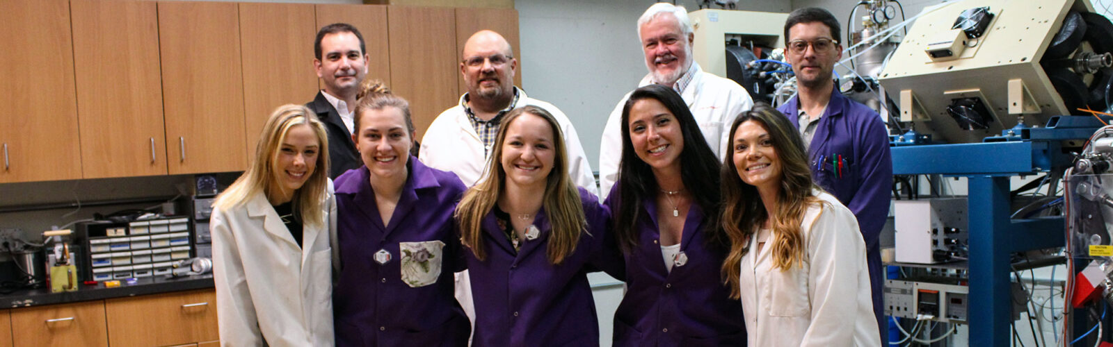 cyclotron team group photo with scientists wearing lab coats
